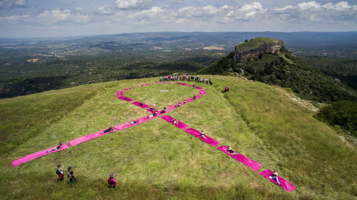 Los viajeros instalan un lazo gigante rosa en las Tetas de Viana en solidaridad con el cáncer de mama